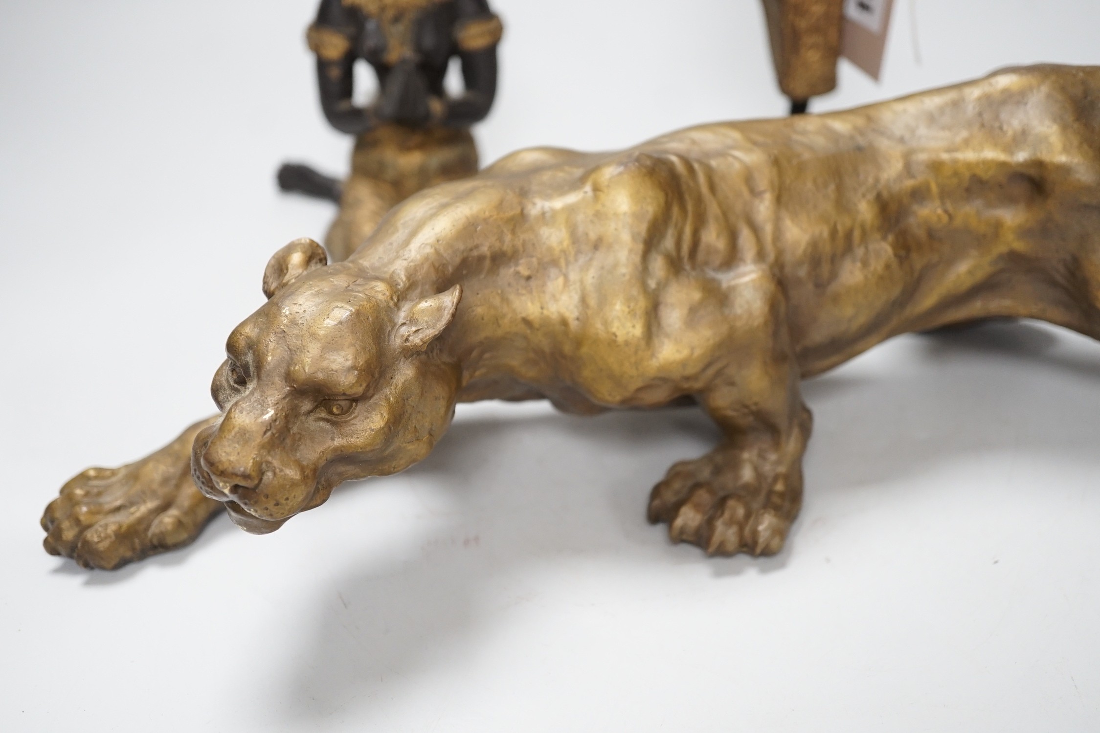 Two two colour Thai patinated metal figures and a hollow cast leopard. Tallest 25cm